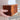 Hand holding a wooden puzzle box with a blurred background