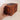 Wooden puzzle box held by a hand on a plain background