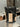 Black bucket with a label on a metallic surface