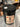 Black bucket labeled 'Beast Wash' on a metallic surface with workshop background