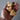 Hand holding three wooden hearts engraved with 'faith', 'hope', and 'love' on a neutral background.