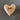 Wooden heart-shaped object with 'faith' engraved on a gray background