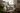 Decorative arrangement of flowers on a wooden bench with a cup and book in a cozy living room.