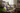 Decorative arrangement of flowers on a wooden bench with a cup and book in a cozy living room.