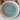 Ceramic plate with a textured blue and white design held by hands.