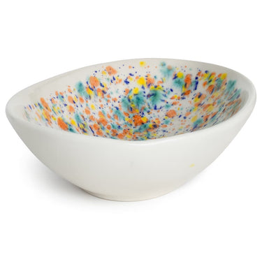 White ceramic bowl with colorful speckled interior on a white background