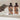 Two bottles of 'Beast Wash' shampoo and conditioner on a bathtub with a hand reaching out.