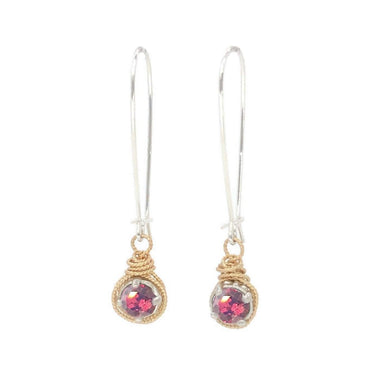 Pair of earrings with pink gemstones and gold wire wrapping on a white background