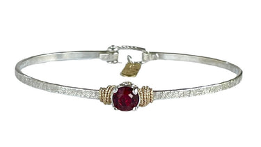 Silver bracelet with a red Crystal on a white background