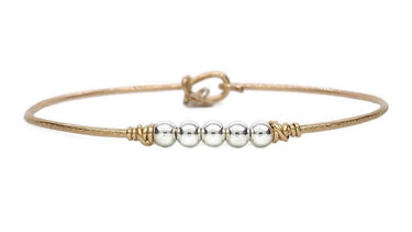 Bracelet with gold and silver beads on a white background
