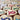 Heart-shaped wooden stamps with colorful ribbon designs on a blurred background