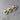 Three wooden heart-shaped pins with blue ribbons on a gray surface