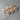Wooden hearts with purple ribbons on a gray surface