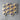 Wooden hearts with blue ribbons on a gray surface