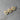 Three wooden heart-shaped pins with blue ribbons on a gray surface
