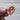 Heart-shaped wooden token with a pink ribbon on a blurred background