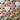 Wooden heart-shaped tokens with colorful ribbons on a wooden surface