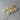 Wooden heart-shaped pins with teal ribbons on a gray surface