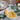 Cheese Borad with cheese and crackers on a table with a glass and flowers in the background
