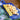 Blue Cheese Borad with yellow crackers and orange cheese cubes on a wooden surface.