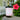 Candle with a label from Key West Candle & Bath Co. with flower on a table outside