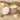 Candle in a tin with 'Key West Candle & Bath Co.' branding on a sandy background with shells and leaves.