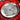 Decorative plate with a cow design on a red patterned fabric background