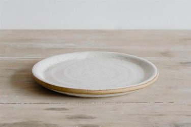 Ceramic plate with a natural edge on a wooden surface