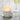 Candle labeled 'Dogwood Dreams' with a glass of champagne on a marble surface