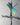 close-up Metallic dragonfly sculpture on a cross on a gray background