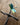 close-up of the dragonfly figurine on an iron cross on a wooden surface