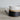 Ceramic earthenware mug with speckled design on a wooden surface