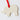White elephant-shaped ornament with a red ribbon on a white background