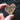 Wooden heart-shaped object with 'Piano Co.' engraving held by a hand against a blurred natural background.