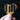 Wooden heart-shaped object with piano key design held by a hand against a dark background
