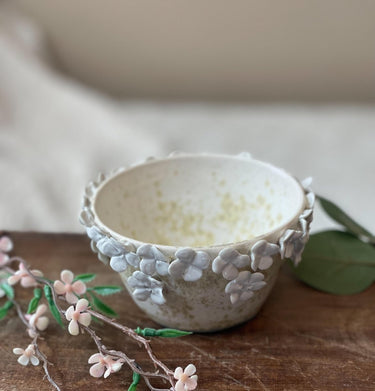 Decorative ceramic Bowl of Posies with floral patterns on a wooden surface