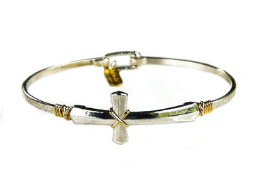 Silver and gold bracelet with a cross charm on a white background