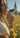 Woman in a field of yellow flowers with a church in the background