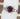 Ring with a purple gemstone on a white stand