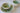 Set of ceramic bowls with green and white glaze on a white surface