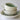 Stack of ceramic bowls on a white plate with a white background