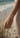 Hand wearing a delicate bracelet on a beach with blurred background