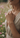 Woman wearing a delicate bracelet with a blurred floral background