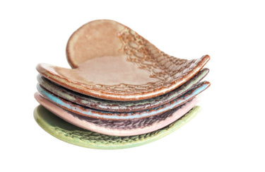 Set of ceramic bowls with textured surfaces on a white background