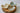 Set of ceramic dishes with gold accents on a wooden stand