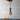 Wooden keychain shaped like a guitar on a plain background