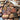 Collection of wooden heart-shaped keychains with various engravings in a box.