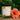 Hemingway Garden Candle – Romantic Floral sitting on a table with hibiscus
