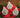 Three decorative Christmas ornaments with intricate designs on a red ribbon with plaid pattern, surrounded by greenery.
