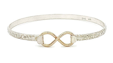 Silver bracelet with gold infinity symbol on a white background